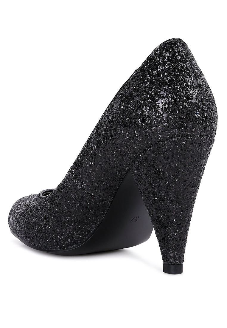 A pair of Sugar Plum Glitter Conical Heel Pumps showcasing a sparkling glitter exterior, conical heels, and a closed toe design, perfect for evening wear.