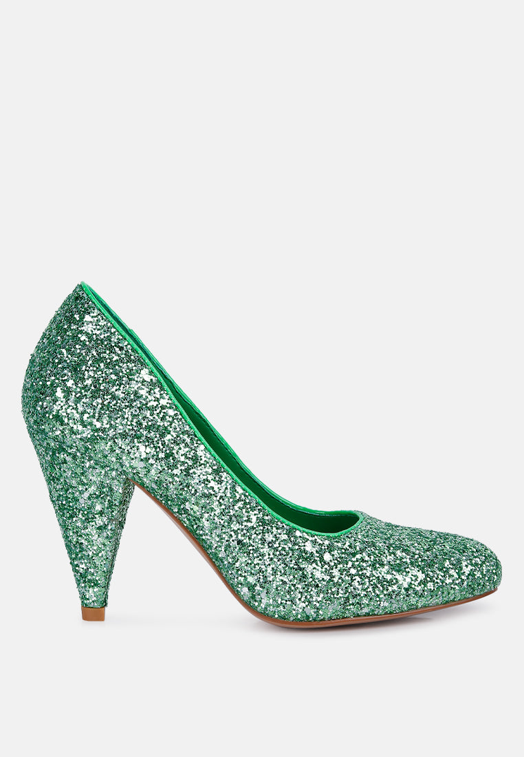 A pair of Sugar Plum Glitter Conical Heel Pumps showcasing a sparkling glitter exterior, conical heels, and a closed toe design, perfect for evening wear.