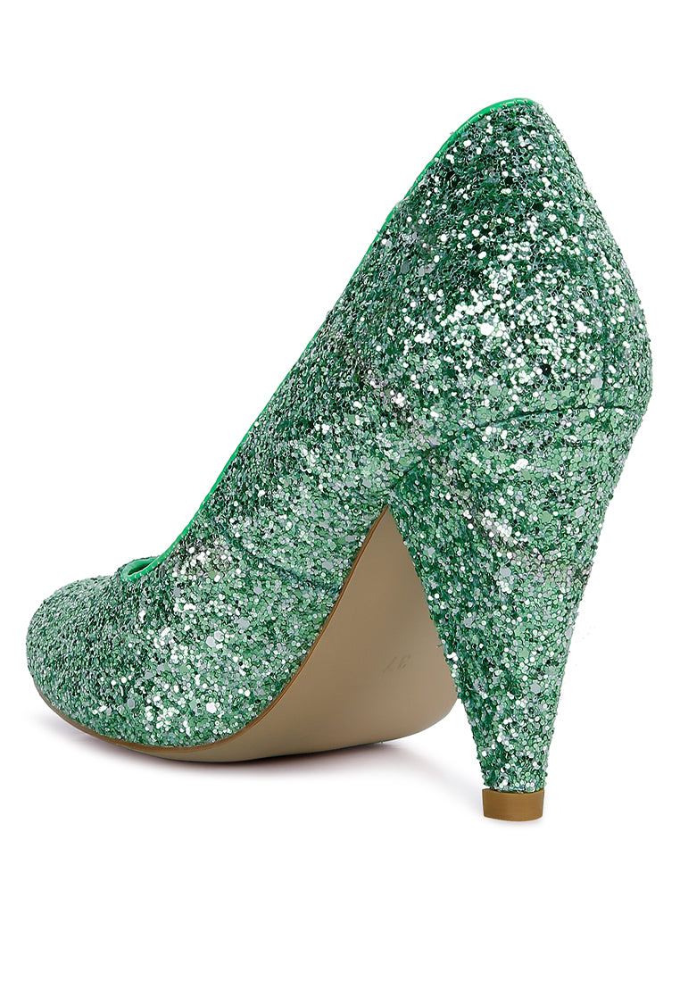 A pair of Sugar Plum Glitter Conical Heel Pumps showcasing a sparkling glitter exterior, conical heels, and a closed toe design, perfect for evening wear.