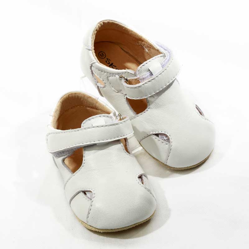 SKEANIE white pre walker sandals for babies, featuring soft leather, hook and loop fastener, and textured sole for grip.