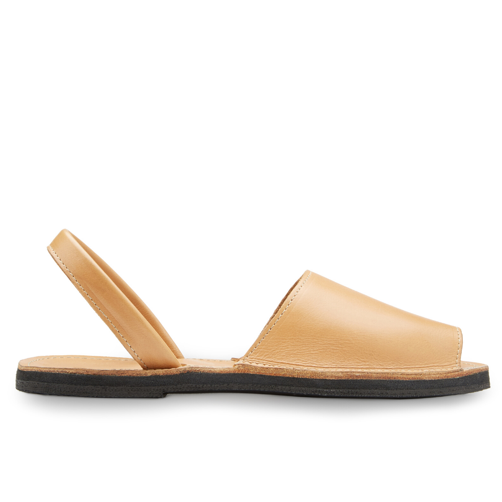 The Avarca women's flat leather sandal in black, showcasing its minimalist design and strappy heel.