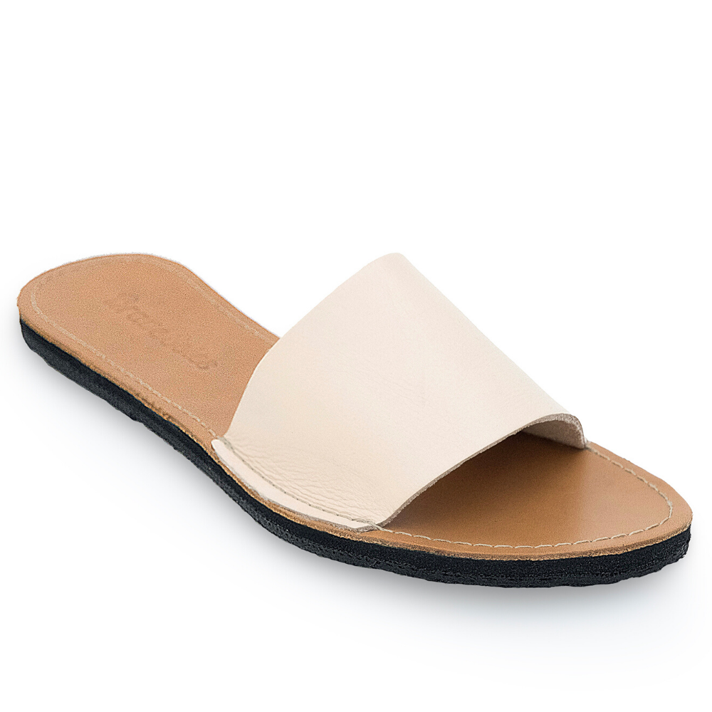 The Linda leather slide sandal, handcrafted with locally sourced leather and upcycled tire soles, showcasing its elegant design and comfort features.