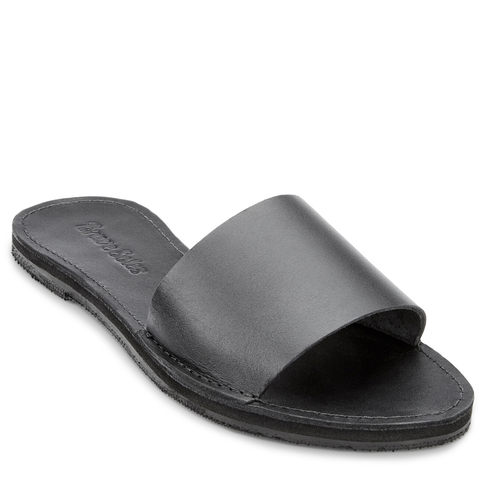 The Linda leather slide sandal, handcrafted with locally sourced leather and upcycled tire soles, showcasing its elegant design and comfort features.