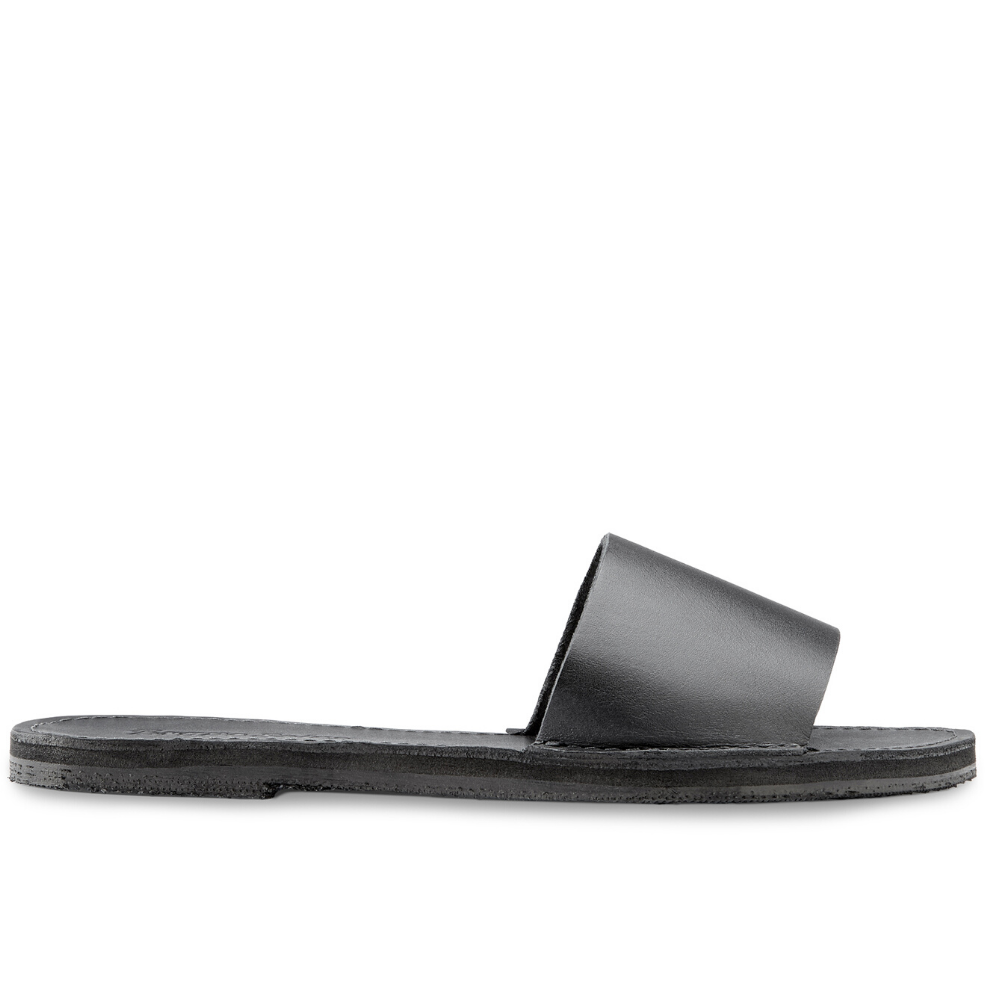 The Linda leather slide sandal, handcrafted with locally sourced leather and upcycled tire soles, showcasing its elegant design and comfort features.