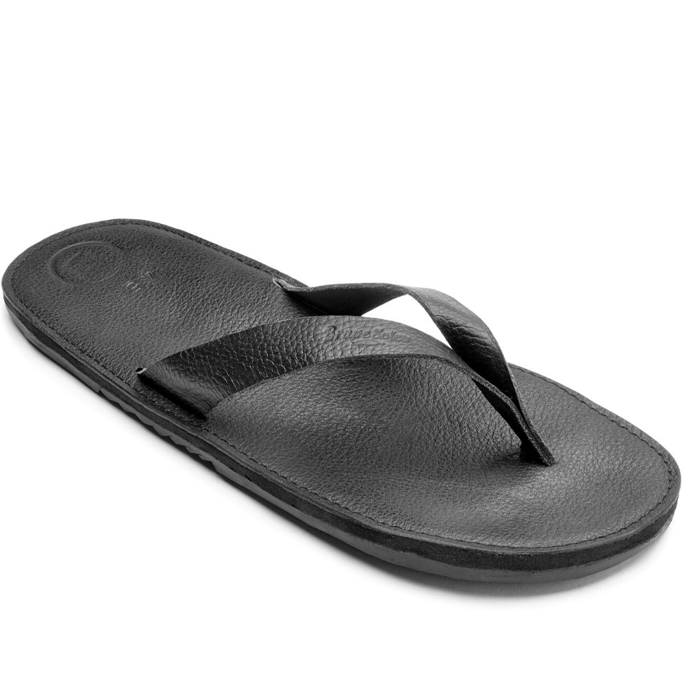 The Novio men's leather flip flops featuring a sleek design with handmade leather footbed and upcycled tire soles.