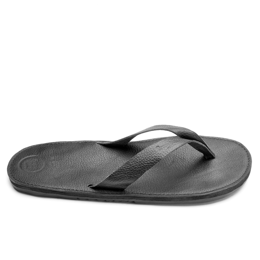 The Novio men's leather flip flops featuring a sleek design with handmade leather footbed and upcycled tire soles.