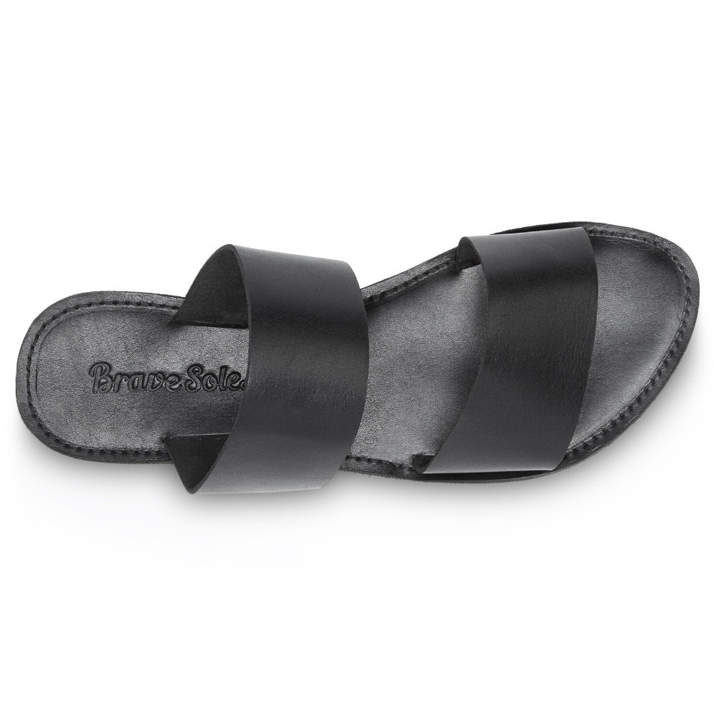 Stylish Ophelia Leather Slide Sandals in black and caramel, featuring minimalist design and eco-friendly upcycled tire soles.