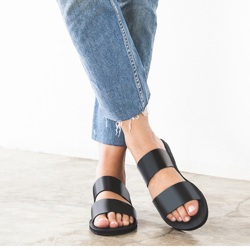 Stylish Ophelia Leather Slide Sandals in black and caramel, featuring minimalist design and eco-friendly upcycled tire soles.