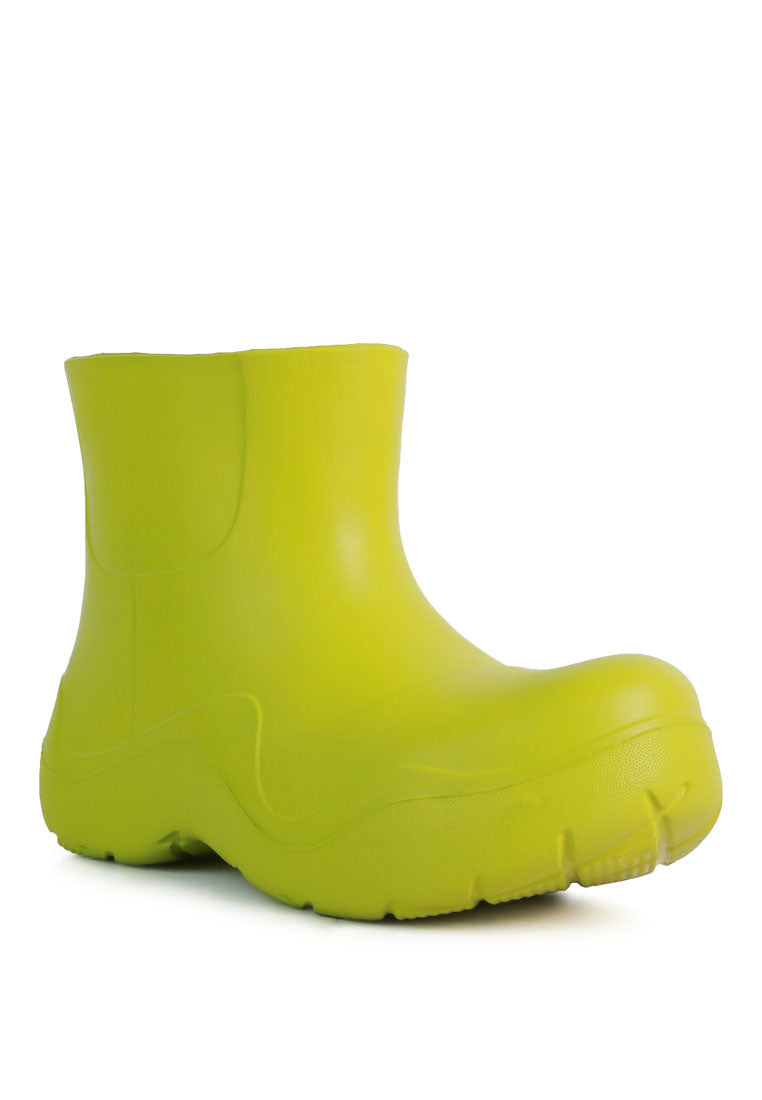 Two Tango Gummy Rain Boots featuring a chunky platform heel, round toe, and vibrant colors, perfect for rainy days and casual outings.