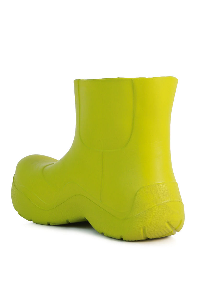 Two Tango Gummy Rain Boots featuring a chunky platform heel, round toe, and vibrant colors, perfect for rainy days and casual outings.