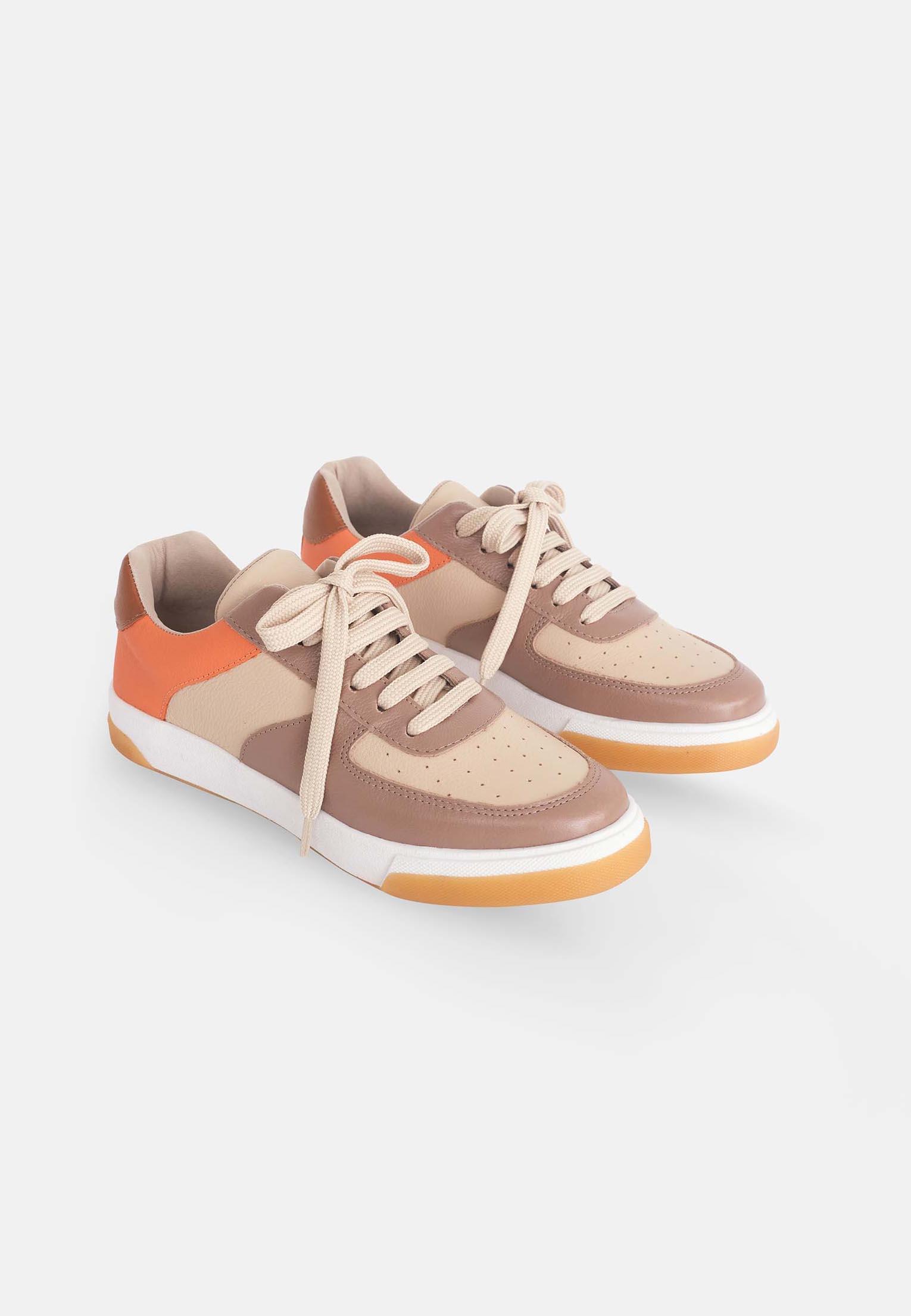 A pair of elegant women's sneakers in beige leather with brown and orange accents, featuring a lace-up front and padded collar.