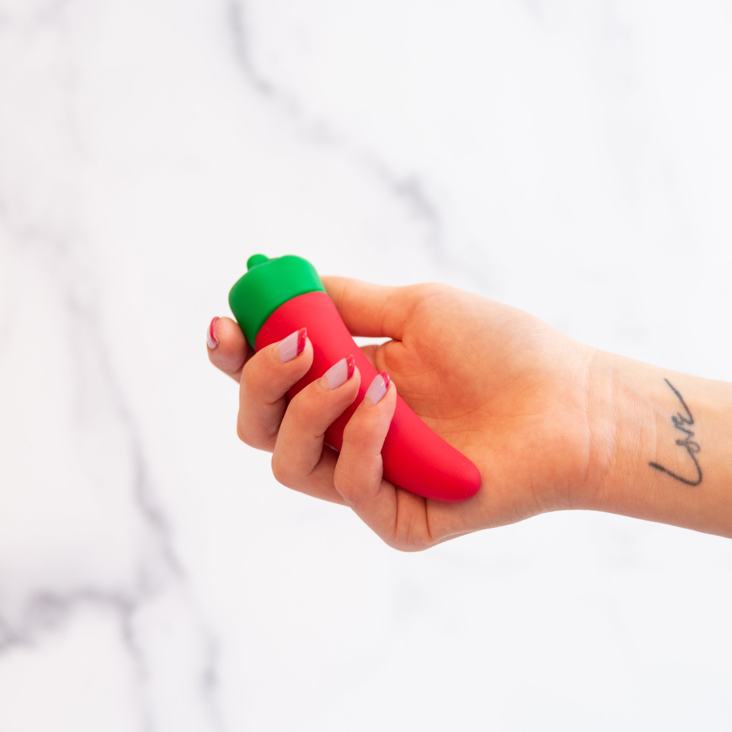 Chili Pepper Emojibator, a vibrant red silicone vibrator shaped like a chili pepper, featuring a bendy tip and buttons for vibration settings.