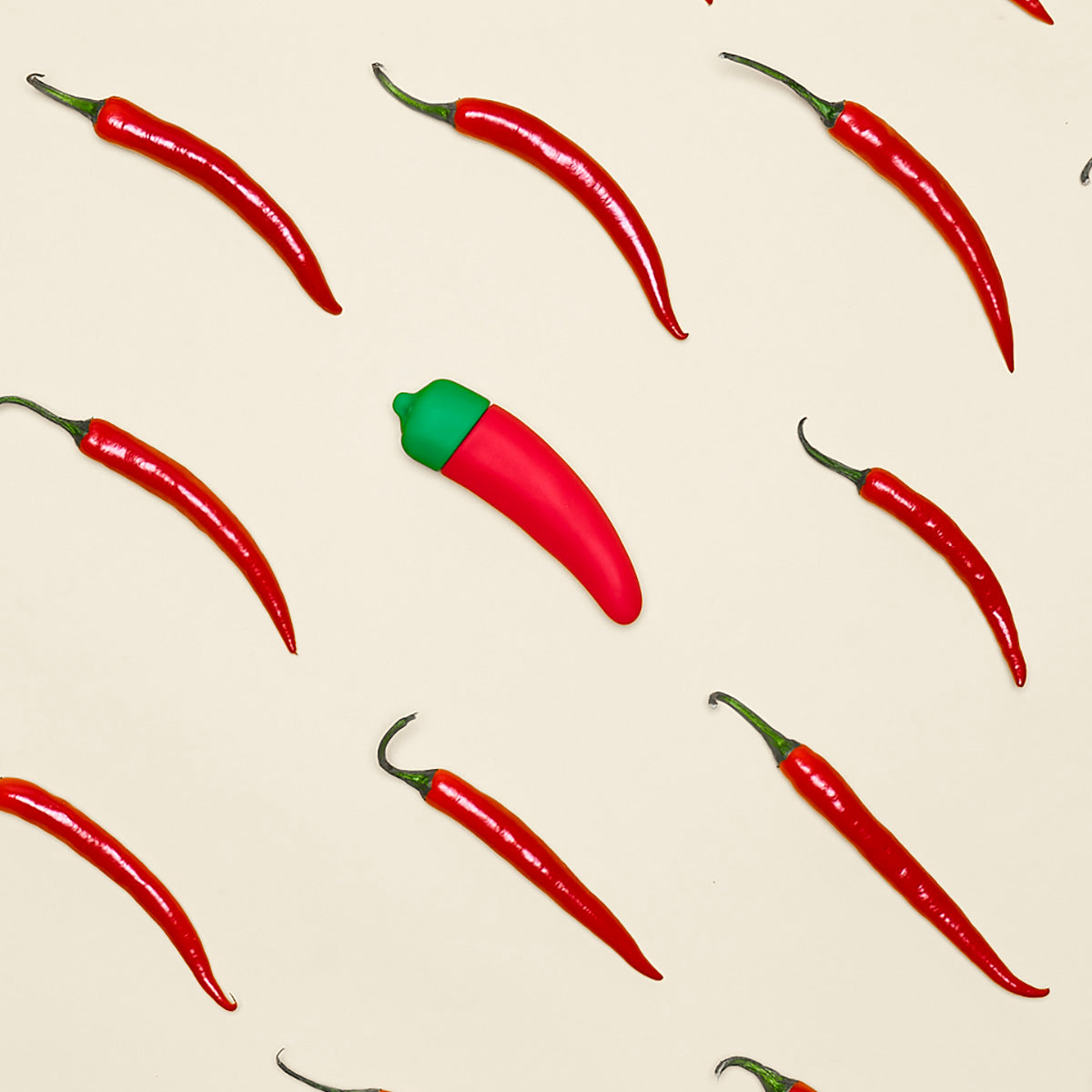 Chili Pepper Emojibator, a vibrant red silicone vibrator shaped like a chili pepper, featuring a bendy tip and buttons for vibration settings.