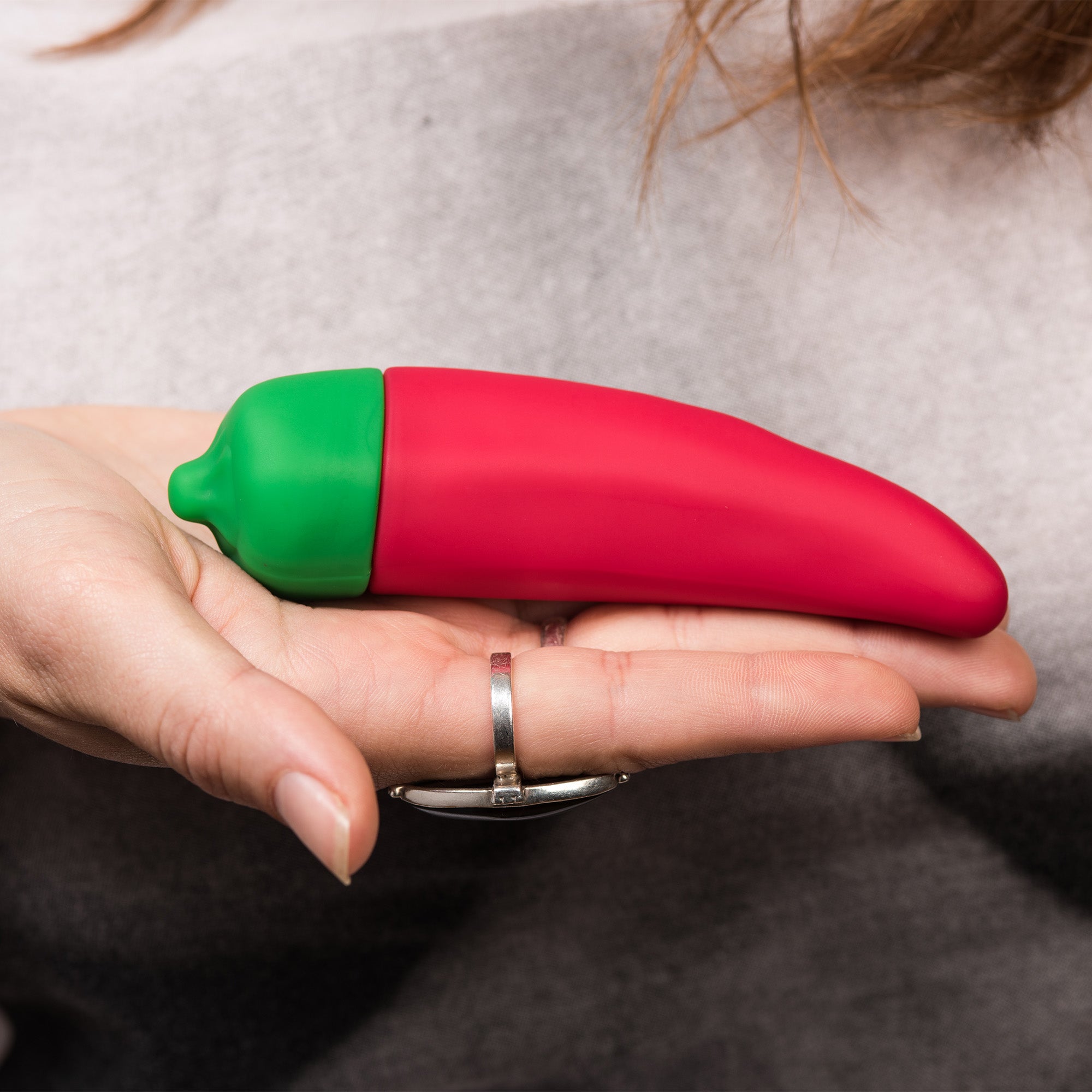 Chili Pepper Emojibator, a vibrant red silicone vibrator shaped like a chili pepper, featuring a bendy tip and buttons for vibration settings.