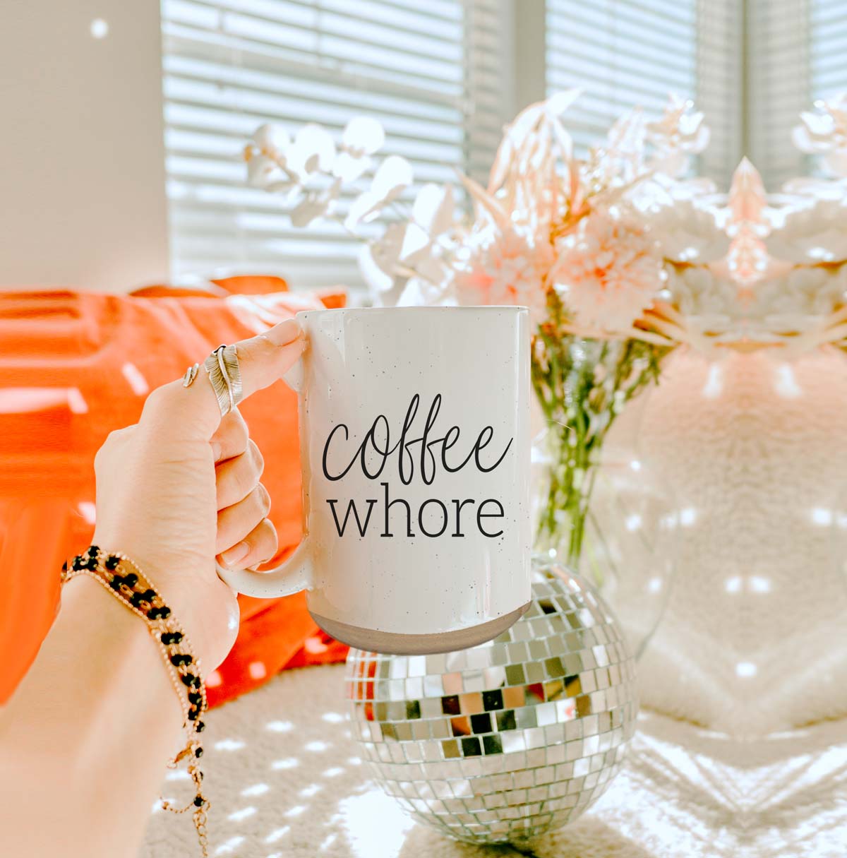 Coffee Whore Ceramic Mug with humorous graphic, off-white color with dark speckles, perfect for coffee lovers.