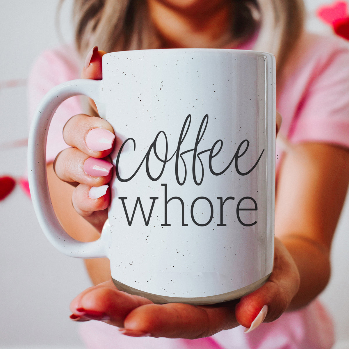 Coffee Whore Ceramic Mug with humorous graphic, off-white color with dark speckles, perfect for coffee lovers.