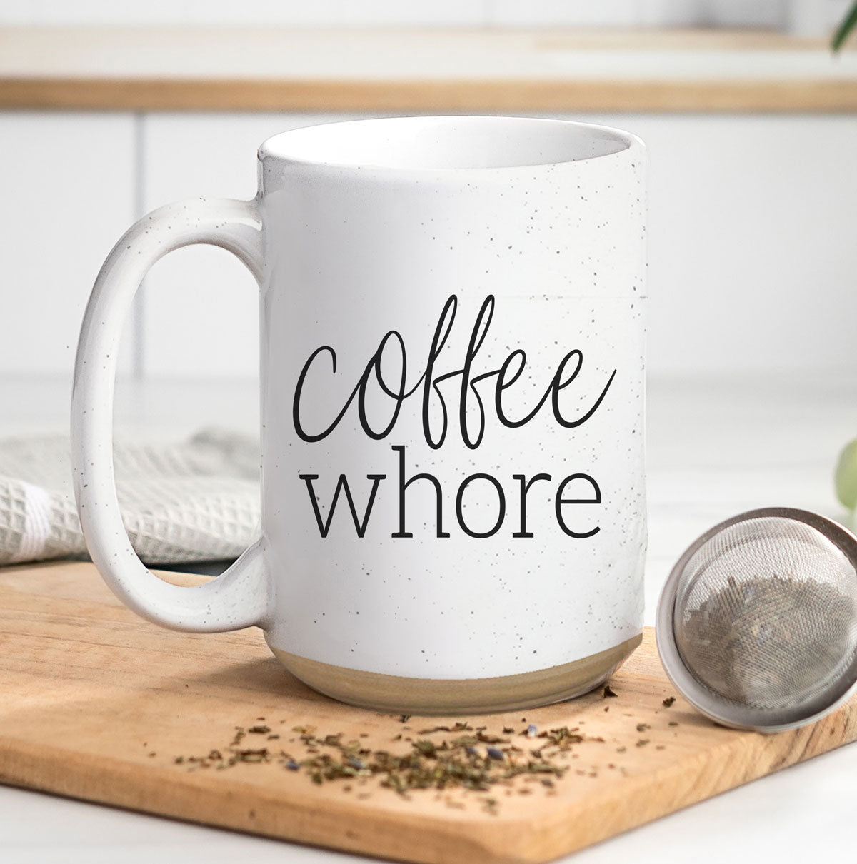 Coffee Whore Ceramic Mug with humorous graphic, off-white color with dark speckles, perfect for coffee lovers.