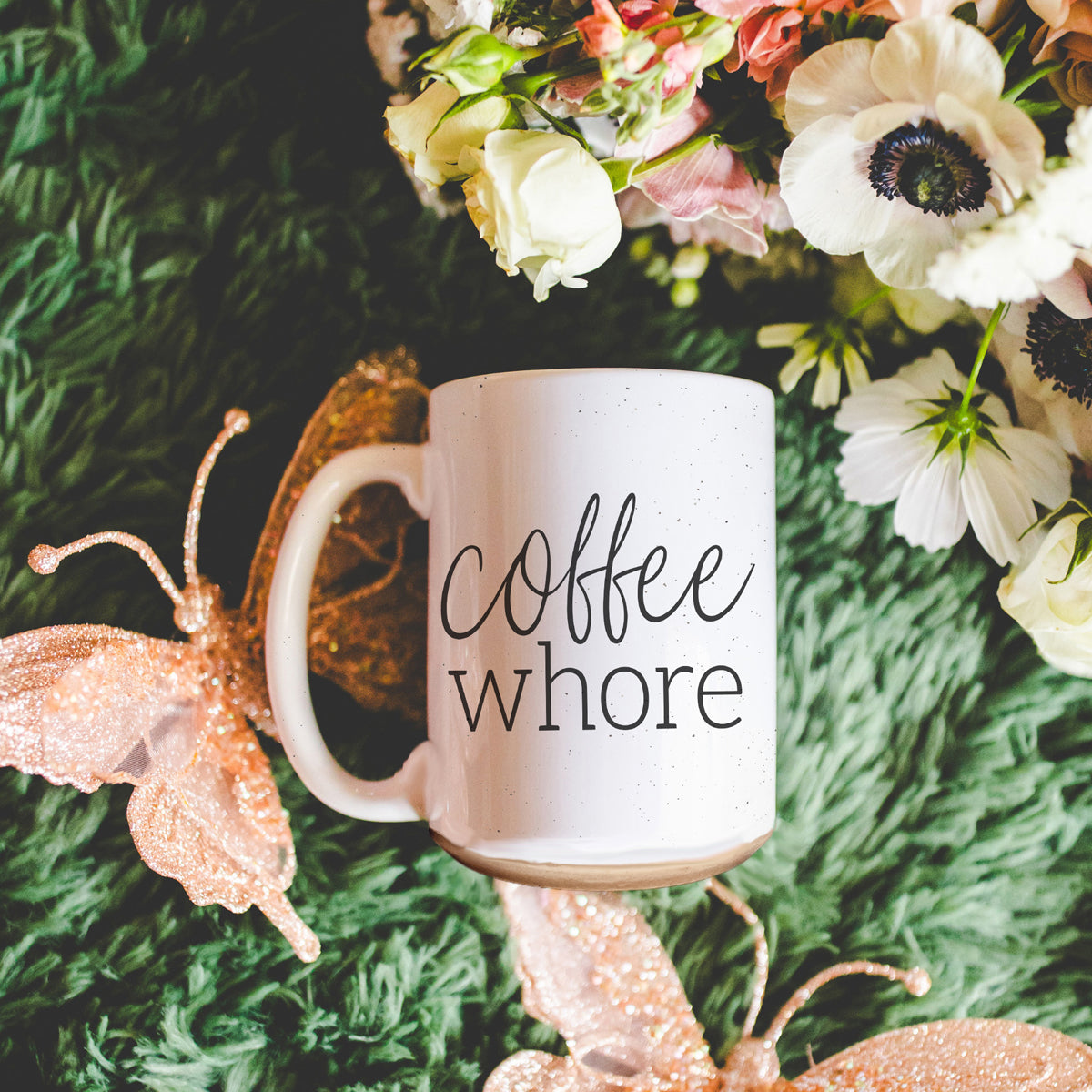 Coffee Whore Ceramic Mug with humorous graphic, off-white color with dark speckles, perfect for coffee lovers.