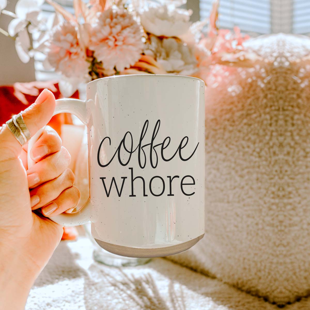 Coffee Whore Ceramic Mug with humorous graphic, off-white color with dark speckles, perfect for coffee lovers.