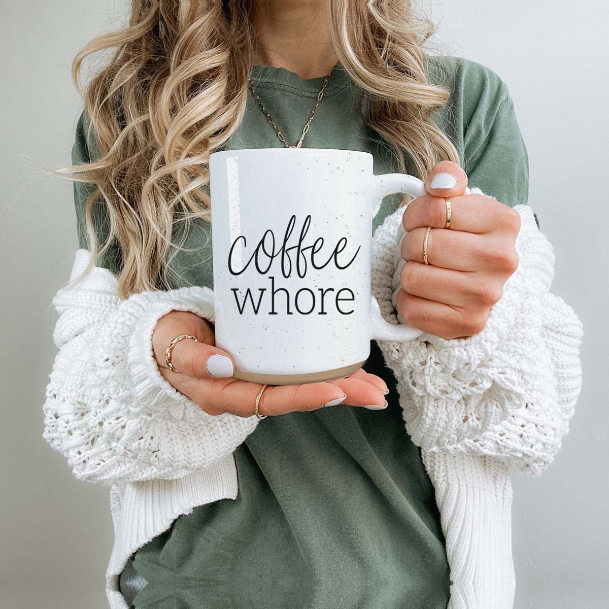 Coffee Whore Ceramic Mug with humorous graphic, off-white color with dark speckles, perfect for coffee lovers.