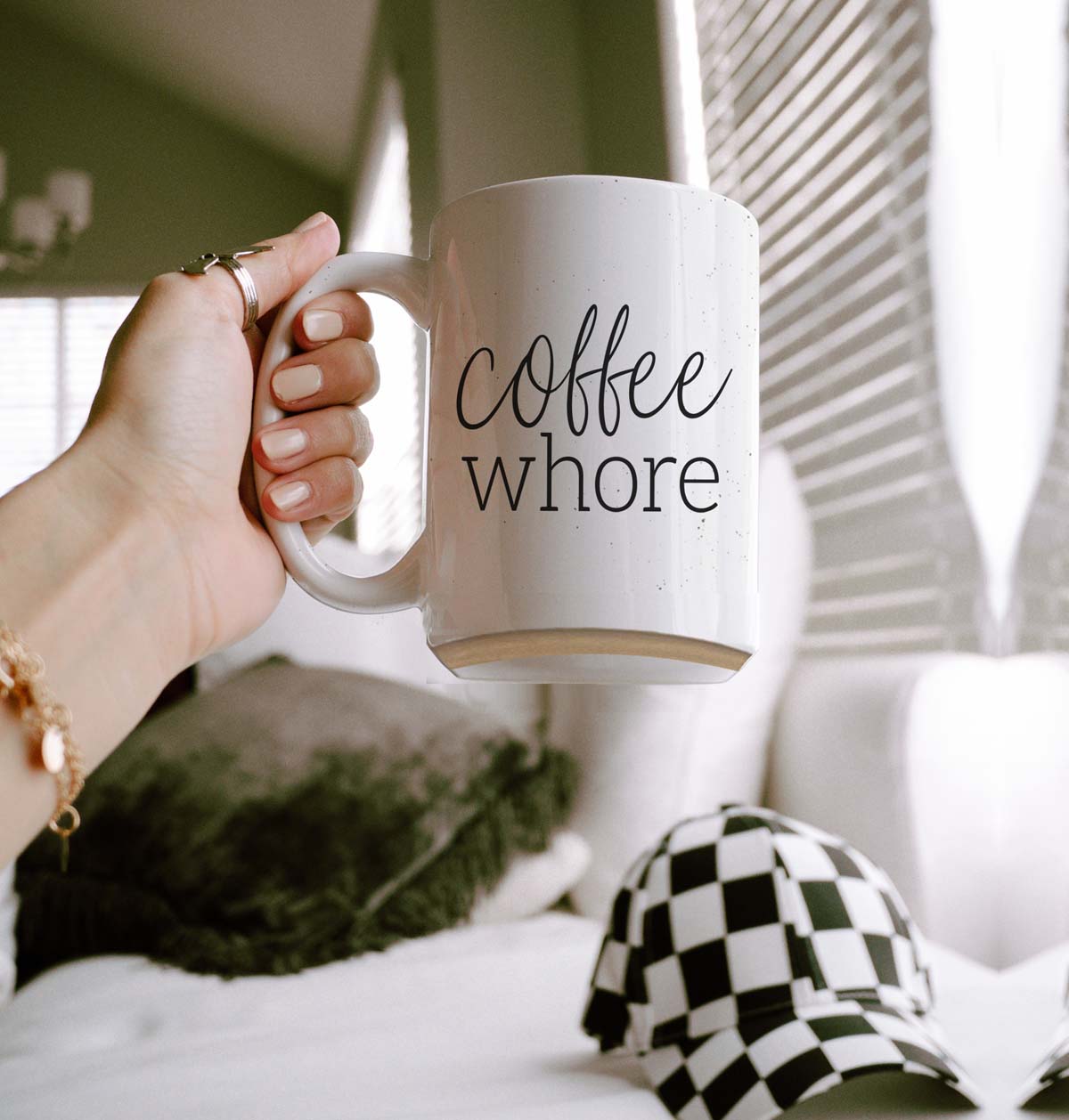 Coffee Whore Ceramic Mug with humorous graphic, off-white color with dark speckles, perfect for coffee lovers.