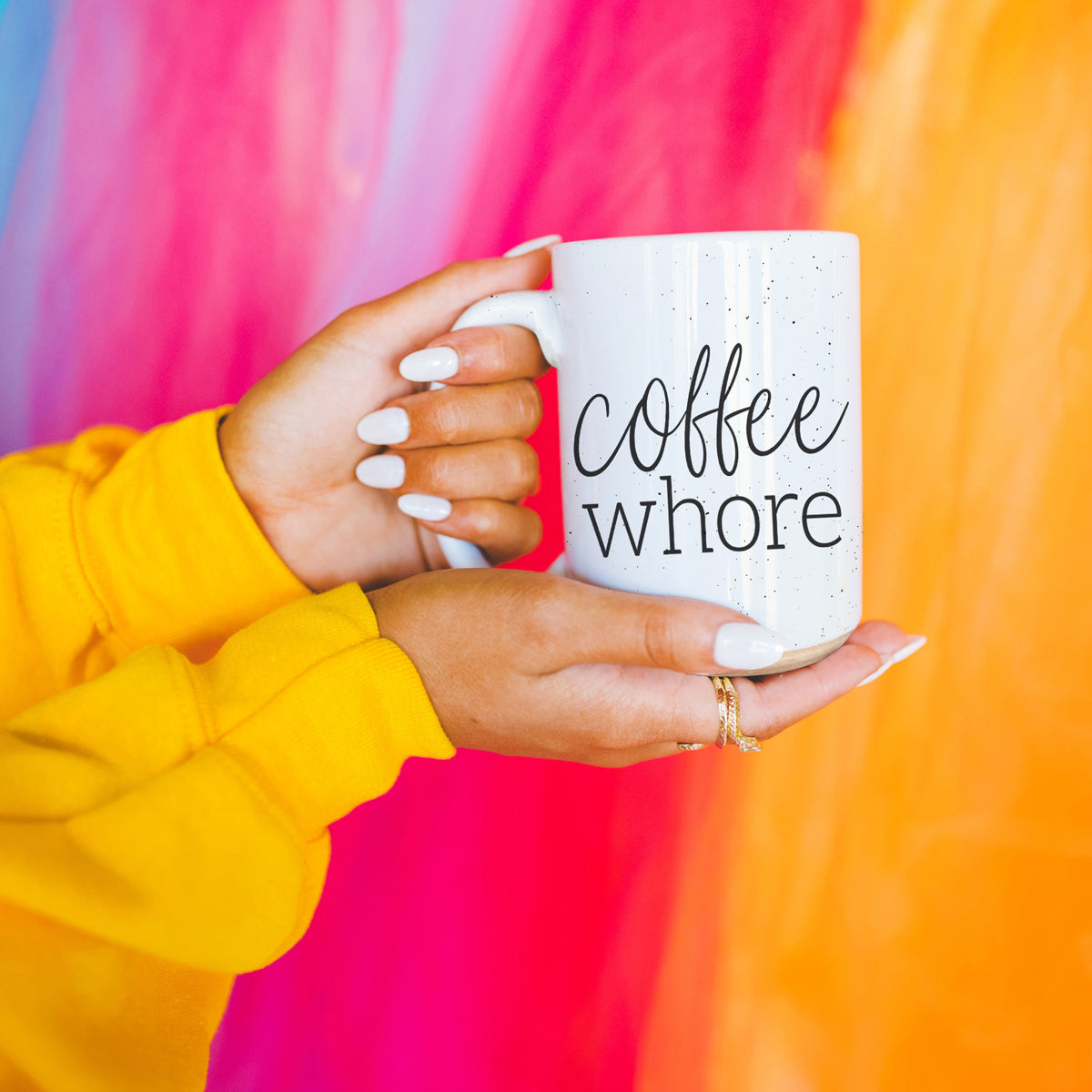 Coffee Whore Ceramic Mug with humorous graphic, off-white color with dark speckles, perfect for coffee lovers.