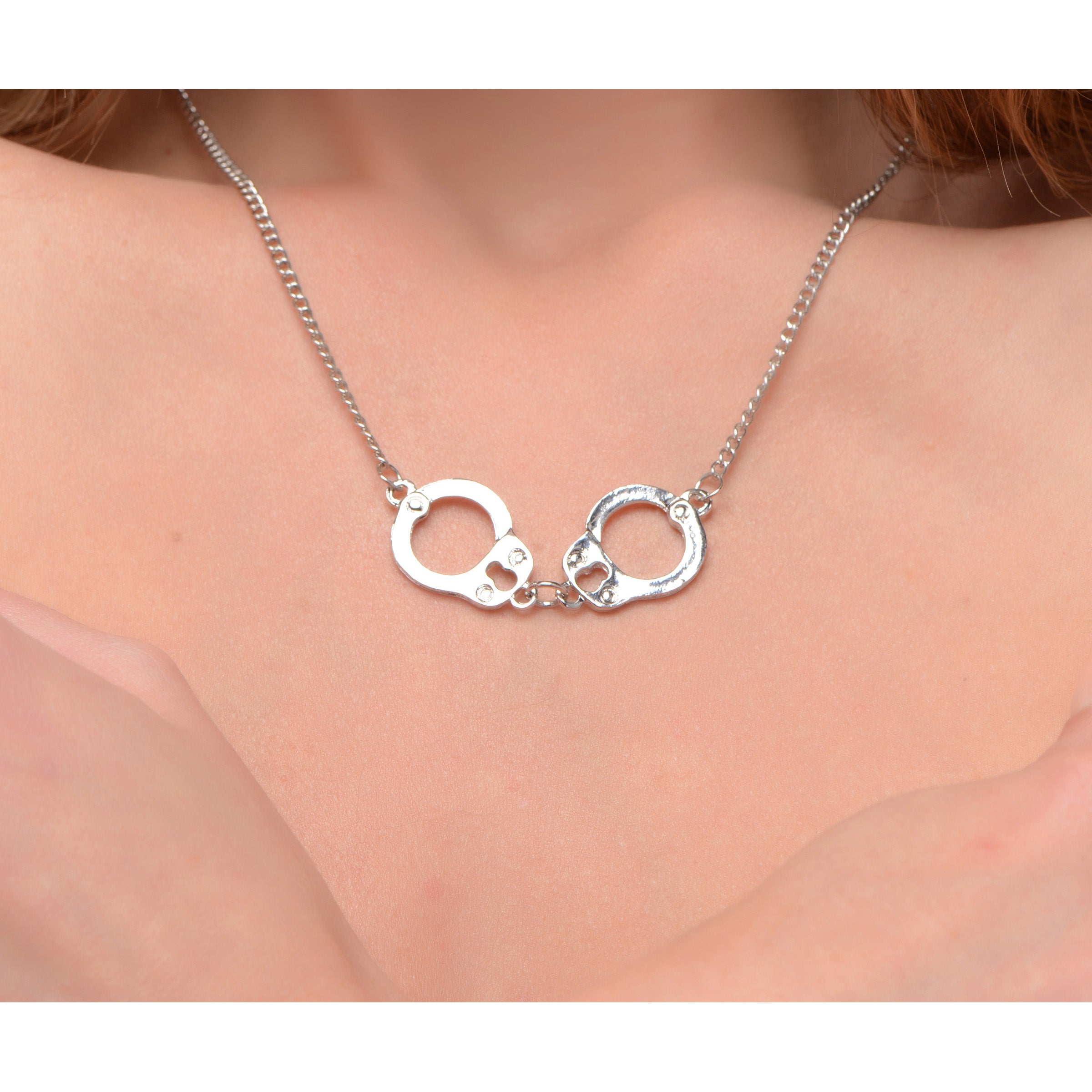 Cuff Her Handcuff Necklace featuring a dainty handcuff design on a grey curb link chain, perfect for stylish expression.