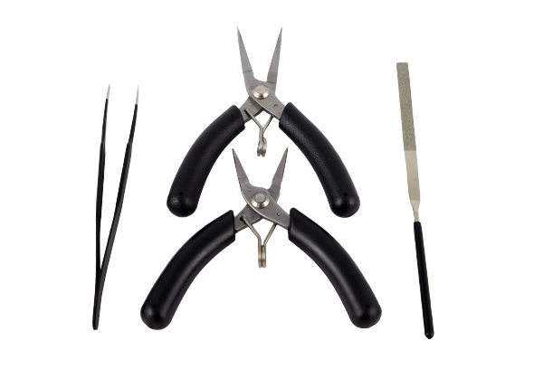 Expert Toolkit for Metal Time models featuring tweezers, pliers, long-nose pliers, and a file, designed for precision assembly and maintenance.