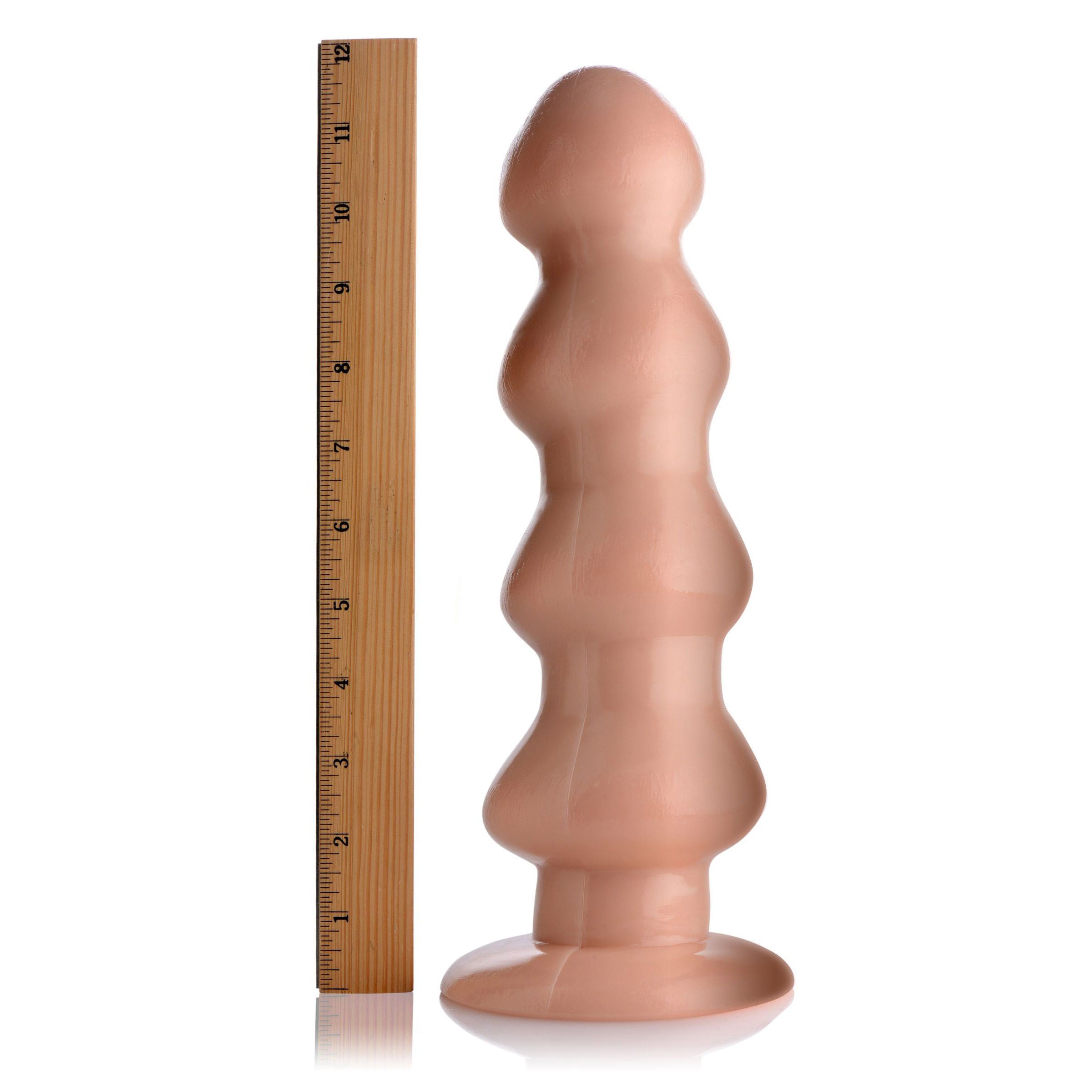 Four Stage Rocket Dildo in light color with four ripples and suction cup base, designed for intense stimulation.