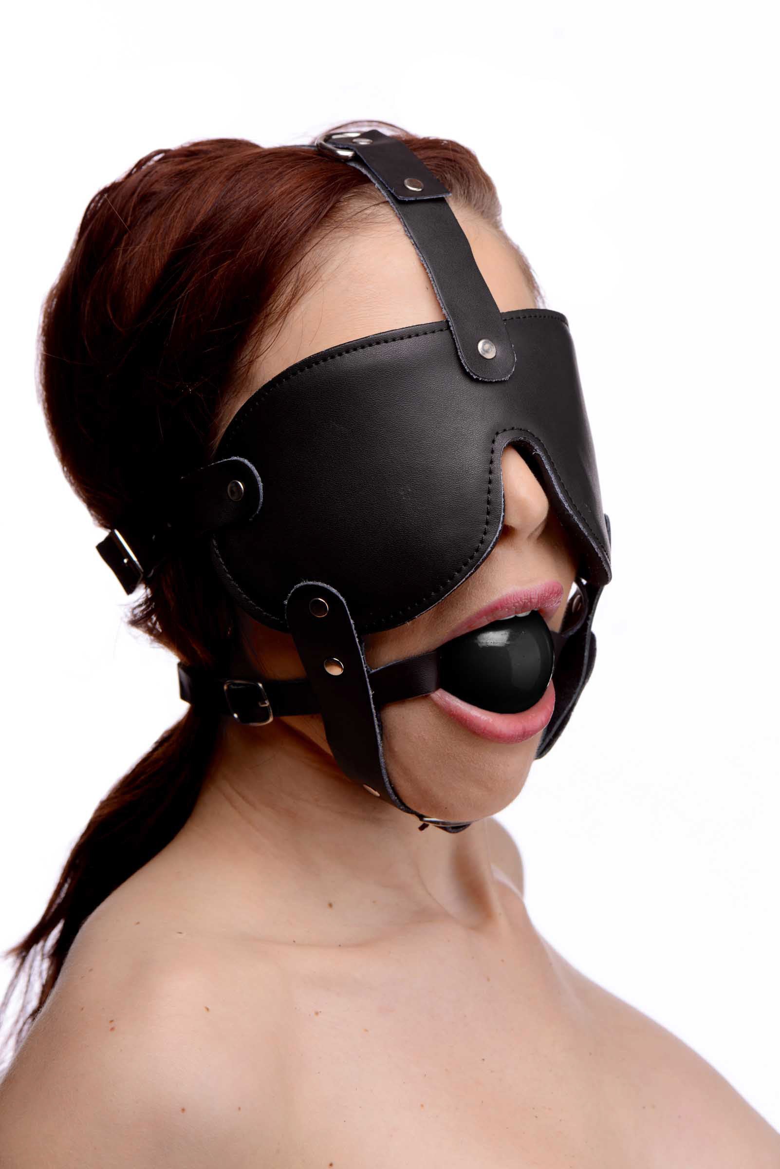 Gag and Blindfold Head Harness featuring a soft leather blindfold and a black rubber ball gag, designed for sensory play.