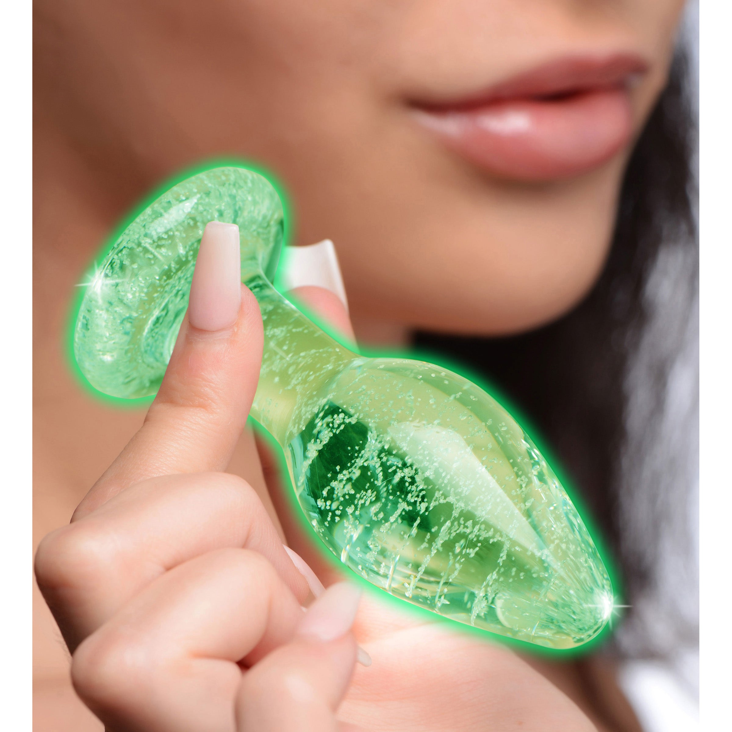 Glow-in-the-Dark Glass Anal Plug showcasing a swirling green pattern, designed for nighttime pleasure.