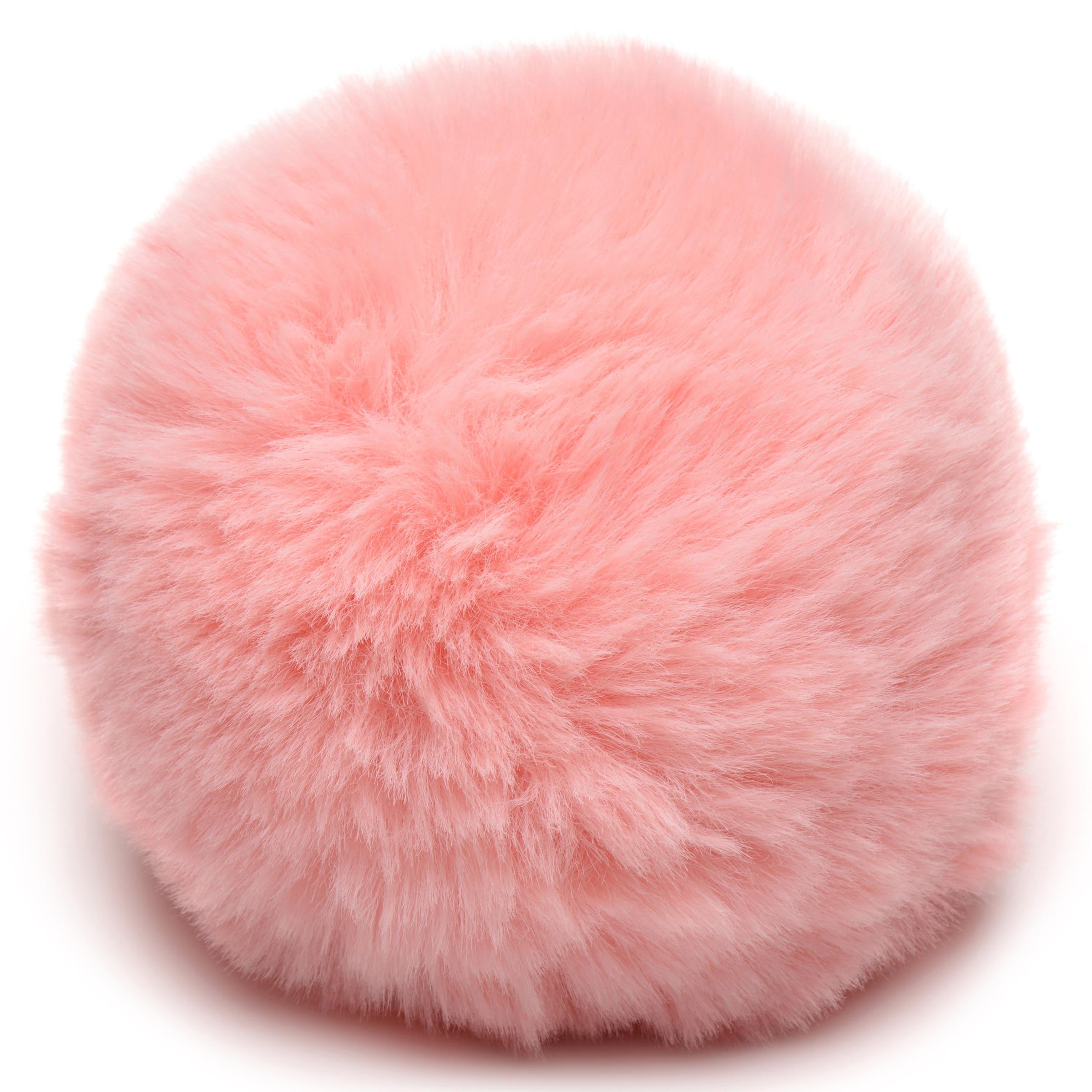 A soft and fluffy pink bunny tail designed for playful animal roleplay, attached to a Snap-On base for easy interchangeability with anal plugs.