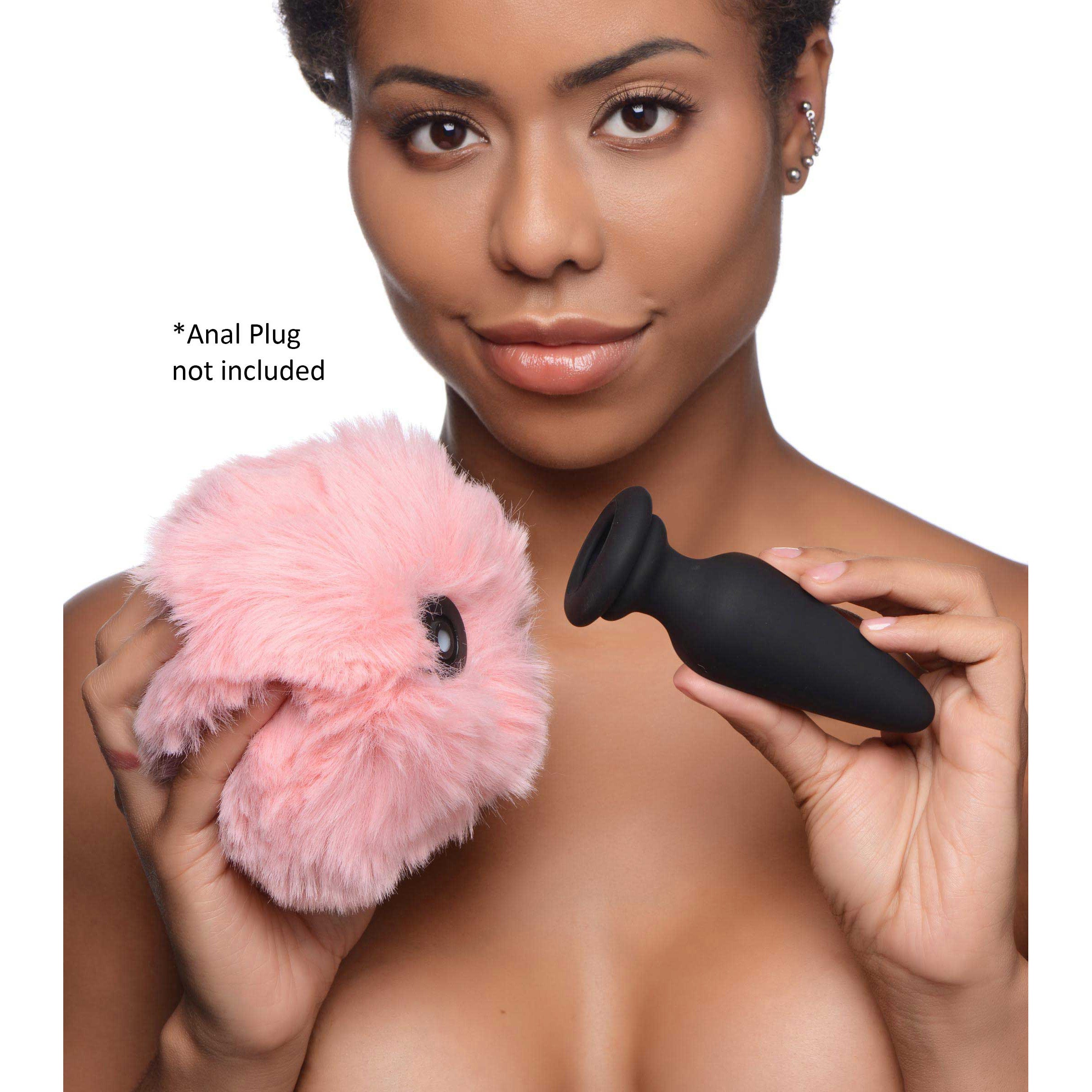 A soft and fluffy pink bunny tail designed for playful animal roleplay, attached to a Snap-On base for easy interchangeability with anal plugs.