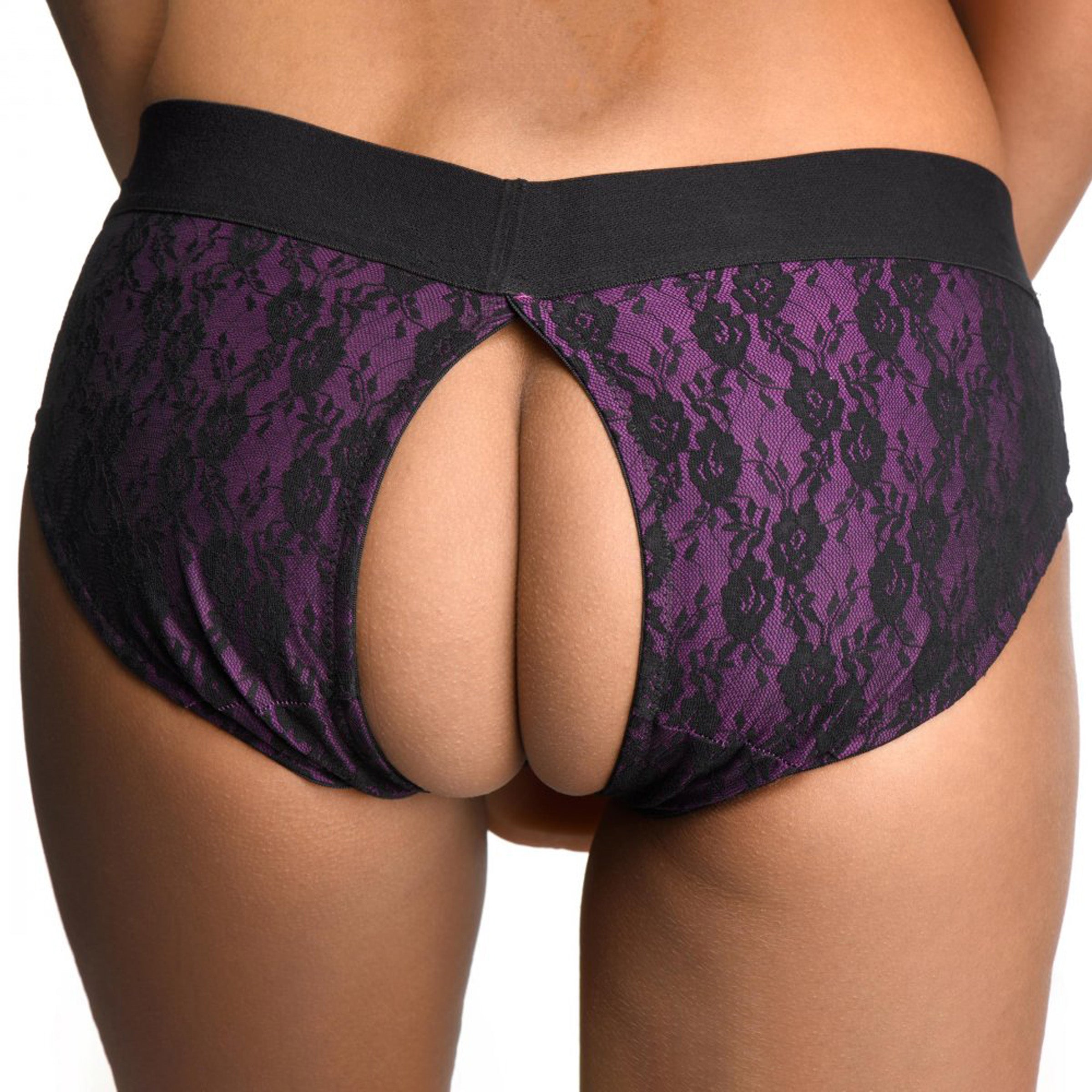 Lace Envy Crotchless Panty Harness in purple and black, featuring a wide elastic strap and universal O-ring for dildos.