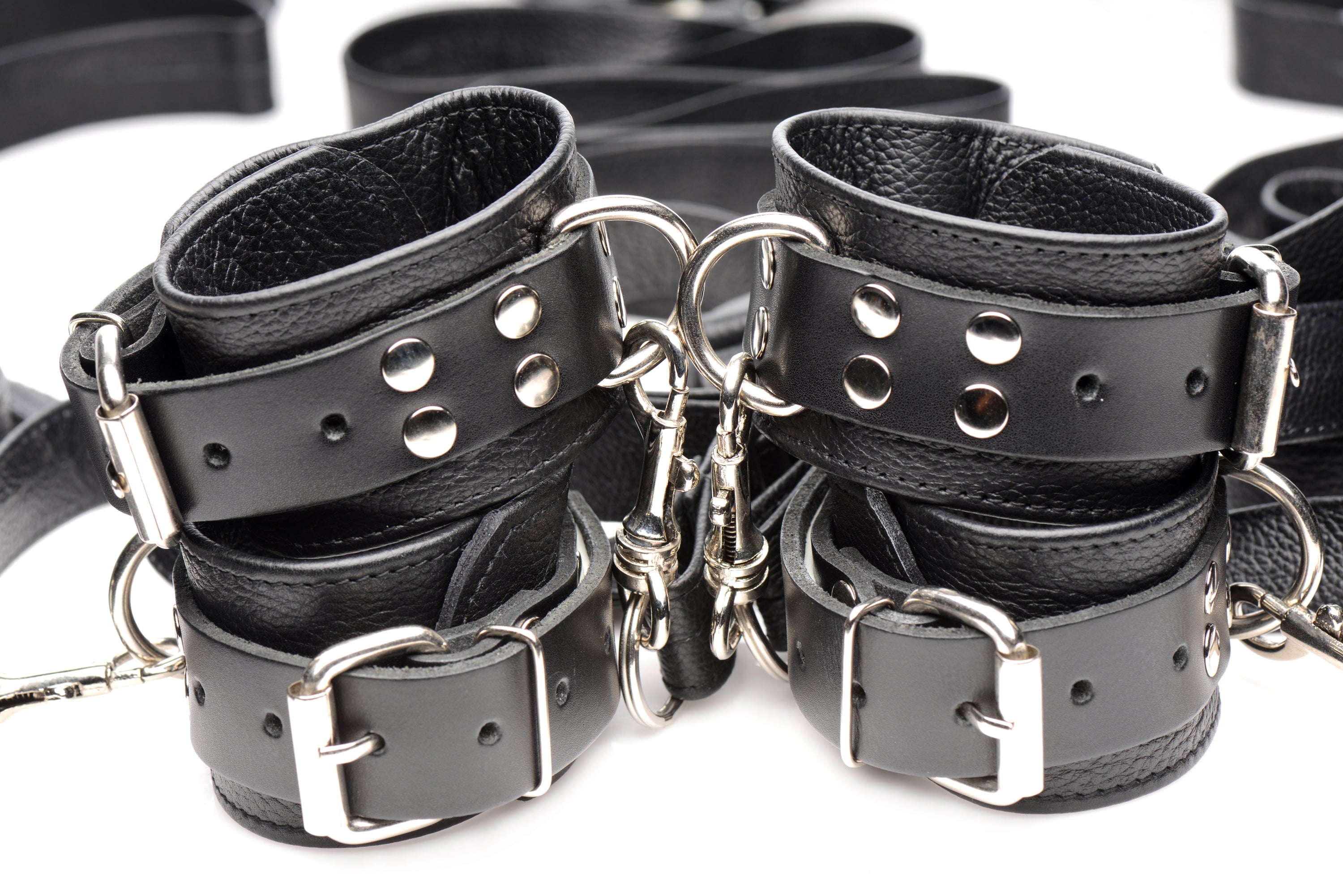 Luxurious Leather Bed Restraint Kit featuring adjustable straps and cuffs for bondage play.