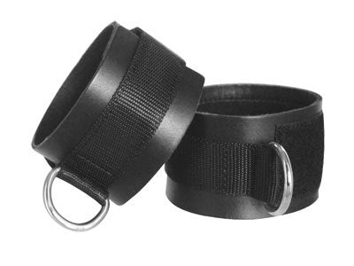 Black leather ankle cuffs with Velcro closure and D-ring for bondage play.