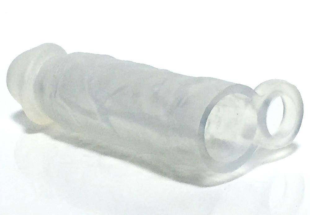 Meaty Cock Extender Clear made of soft touch silicone, showcasing its translucent design and added length and girth features.