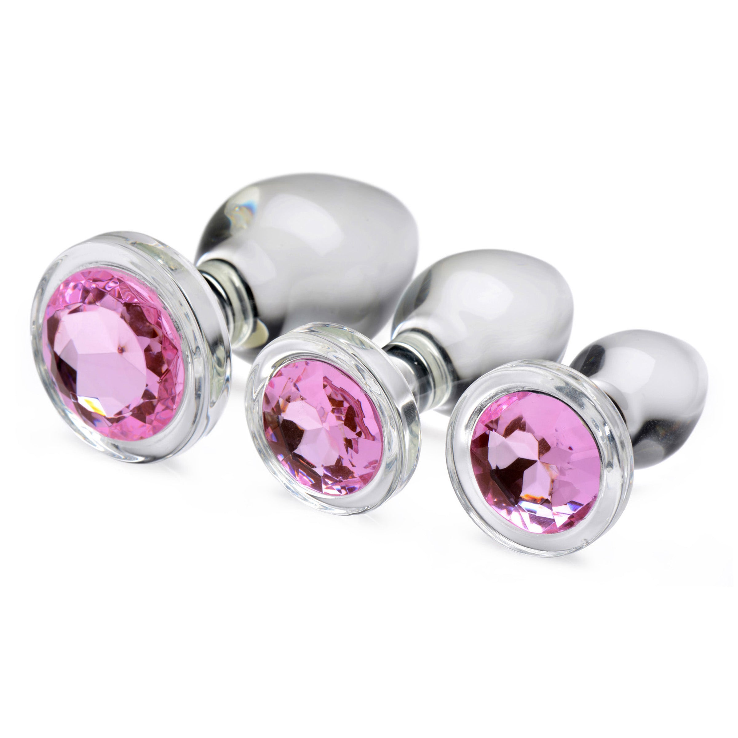 A set of three pink gem glass anal plugs, showcasing their smooth surface and tapered design for comfortable use.