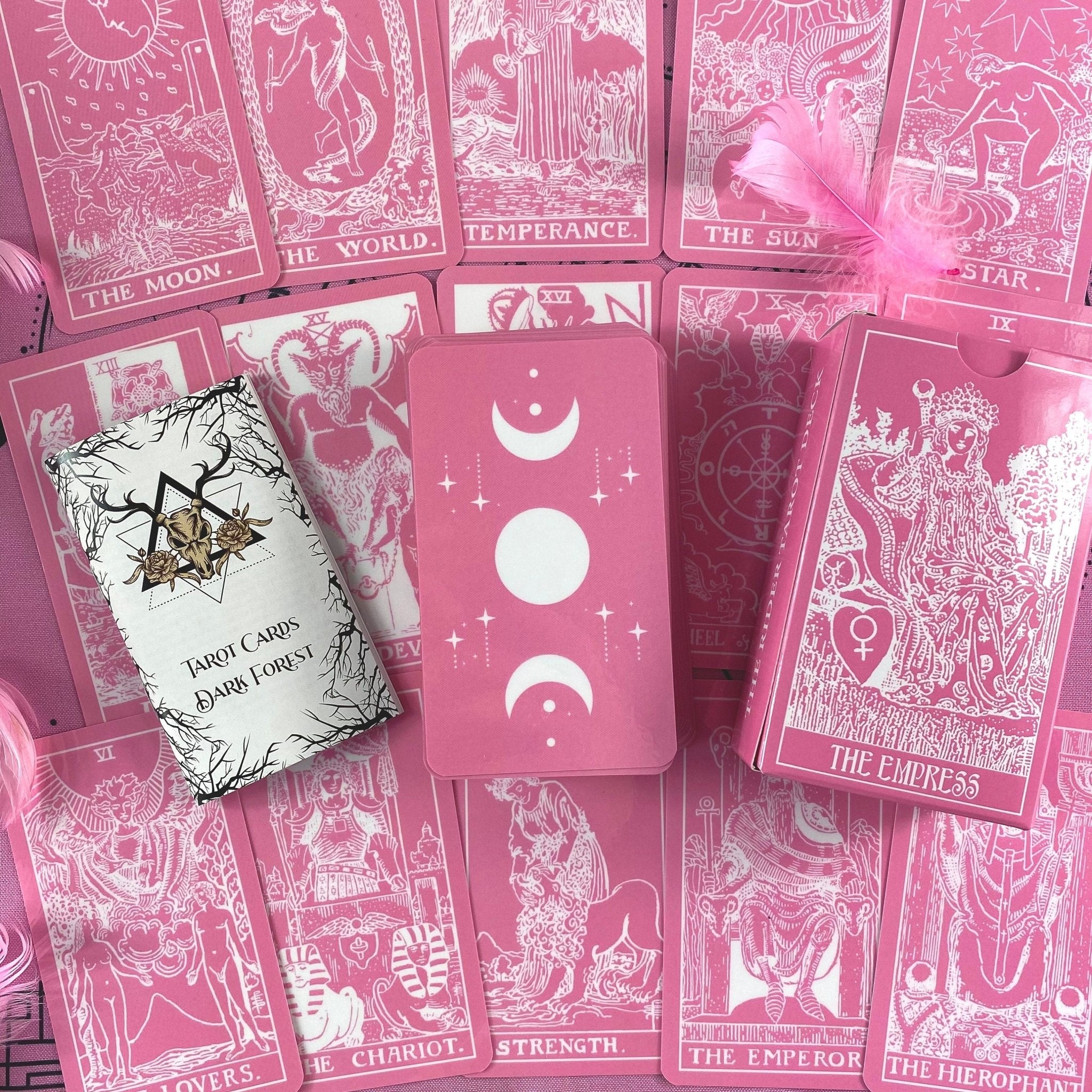 Pink White Tarot Deck featuring 78 cards, a guidebook, and stylish accessories including a velvet bag and wooden box.