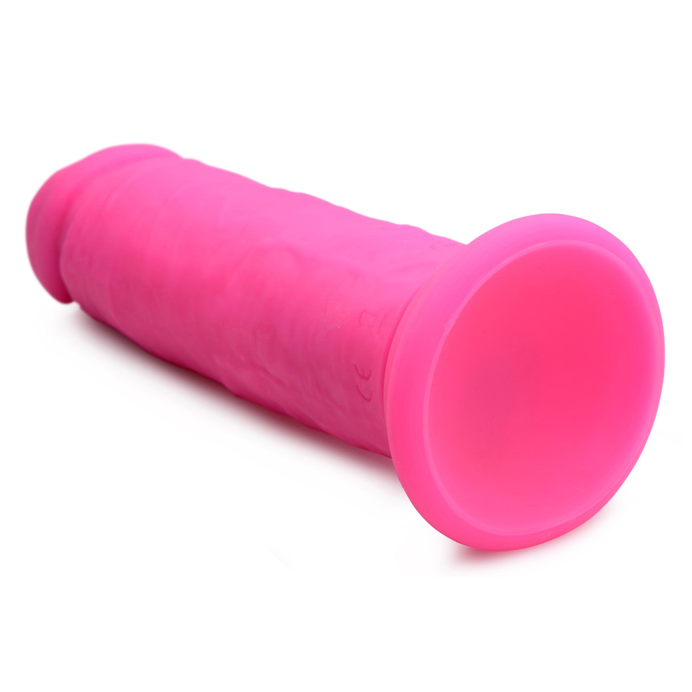 Power Player 28X Vibrating Silicone Dildo in pink with remote control, showcasing its realistic design and suction cup base.