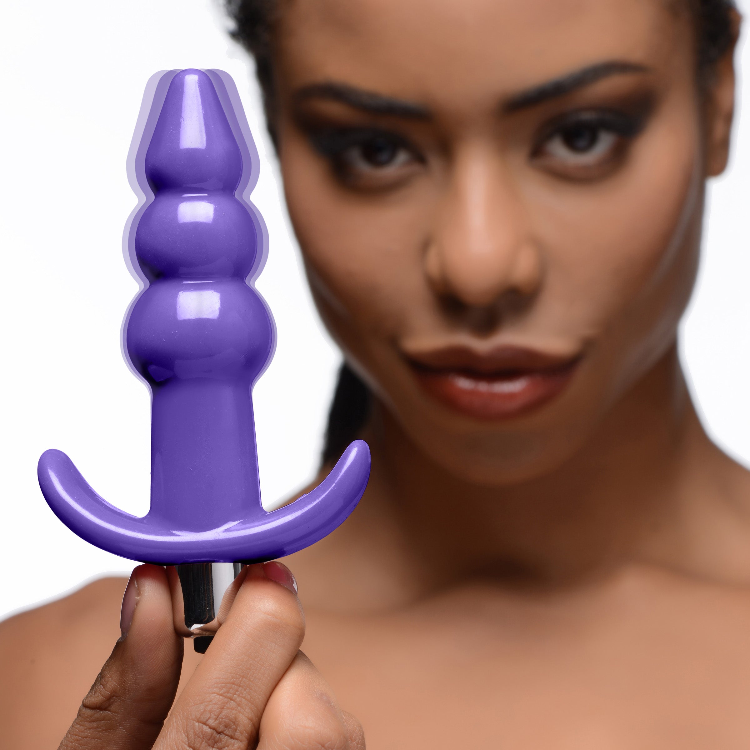 Ribbed Vibrating Butt Plug in Purple with three bulbs and a tapered tip, designed for comfortable anal play.