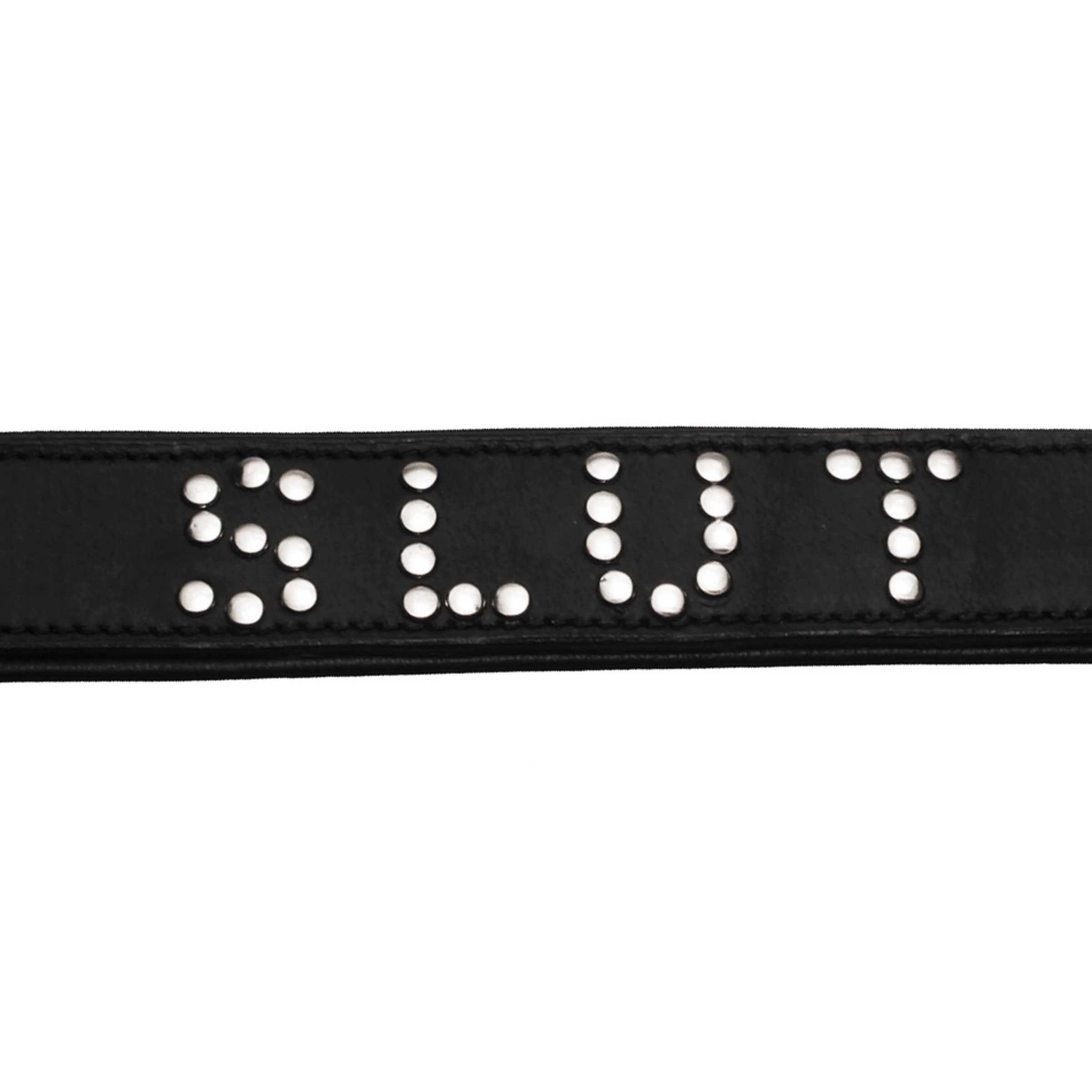 A luxurious black leather collar with silver studs spelling 'SLUT', featuring a padded design and adjustable buckle closure.