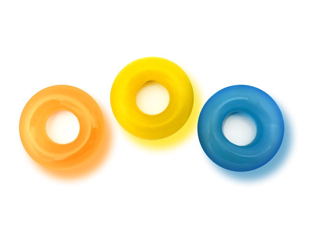 The D-Ring Glow X3 set featuring three colorful glow-in-the-dark rings in blue, orange, and yellow, designed for enhanced pleasure and support.