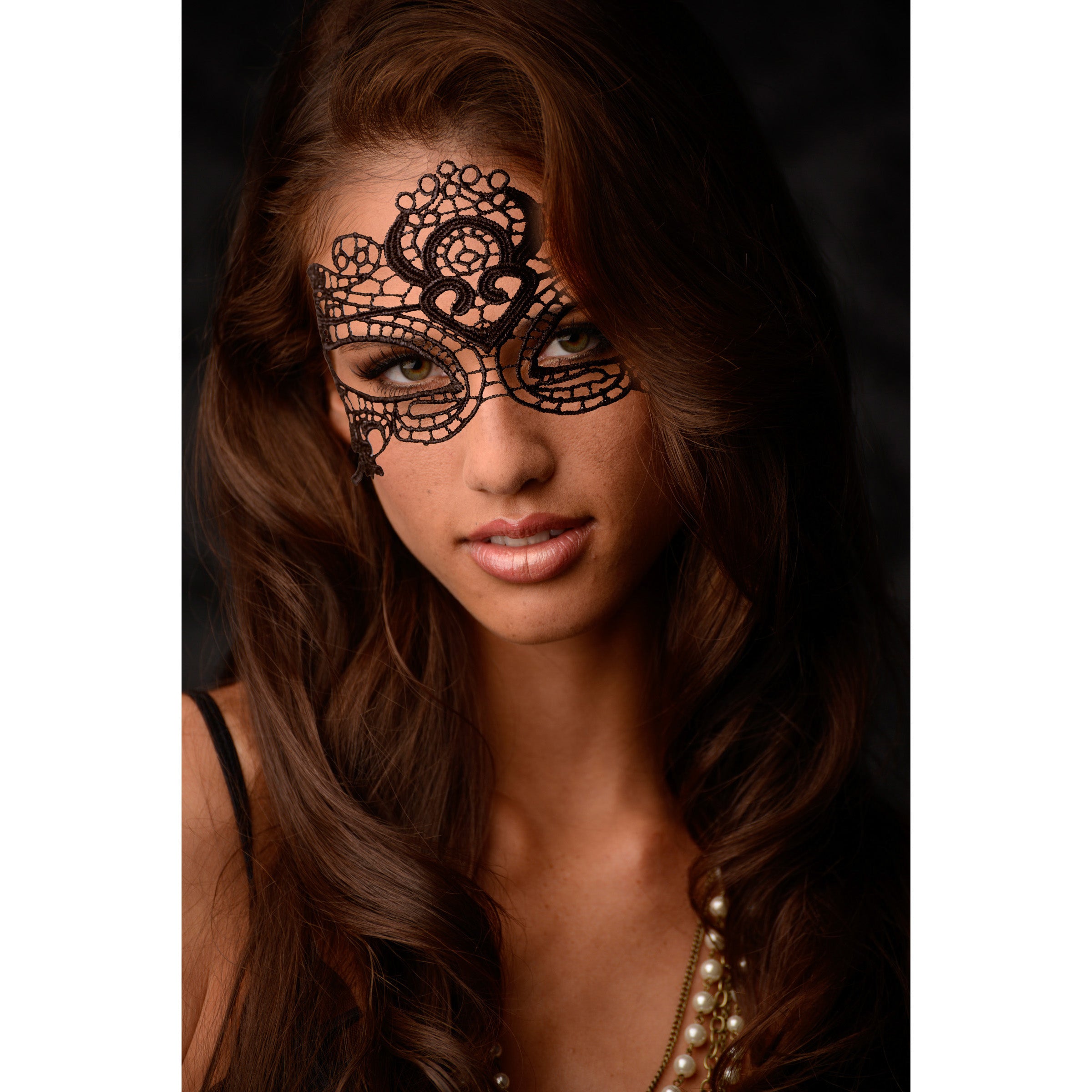 The Enchanted Black Lace Mask showcasing intricate lace details and open eye design, secured with delicate lace ties.