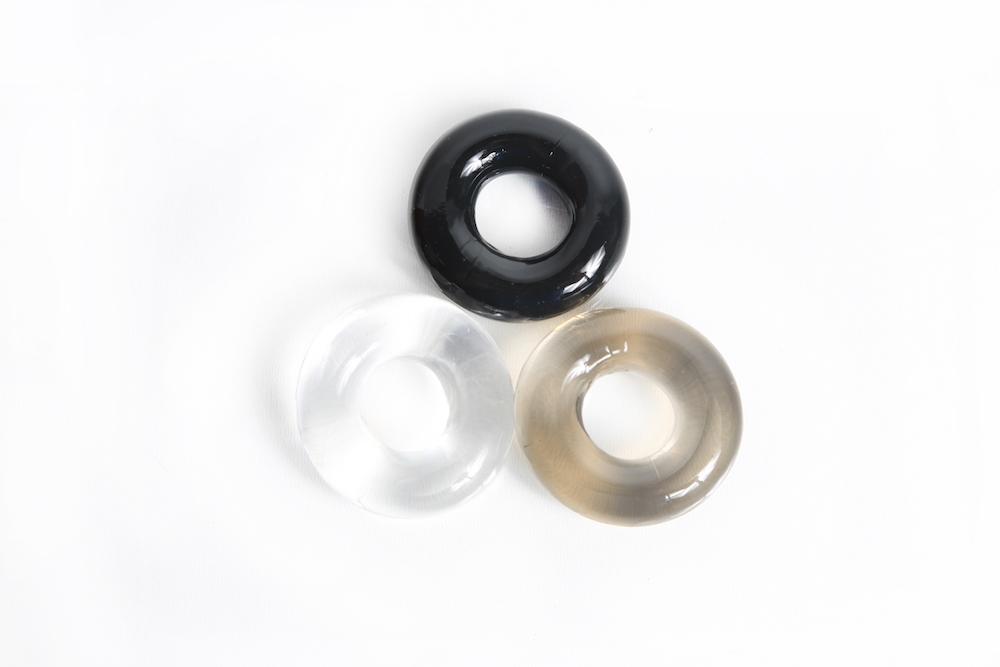 Triple Play Cock Ring set featuring three rings in black, clear, and smoke colors, made from stretchy TPE for comfort and support.