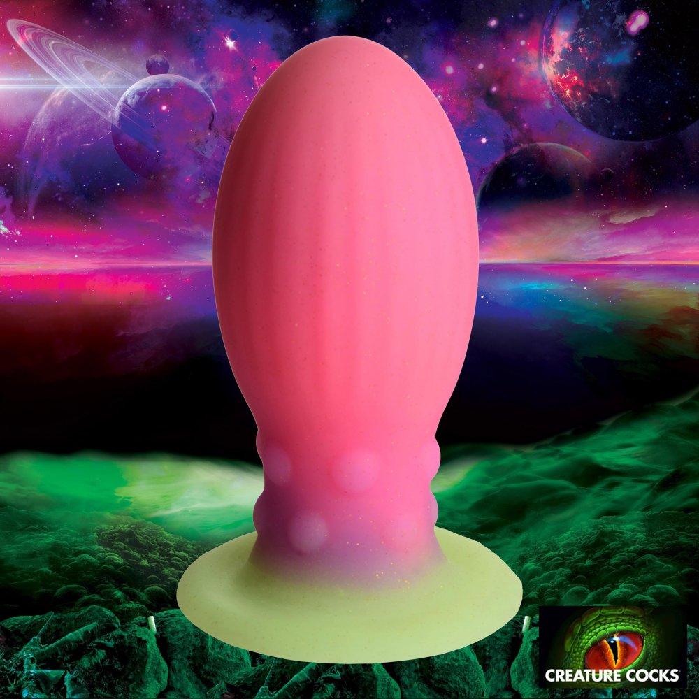 XL Xeno Egg Glow in the Dark Silicone Egg in vibrant pink, purple, and green colors, showcasing its ribbed texture and tapered tip.