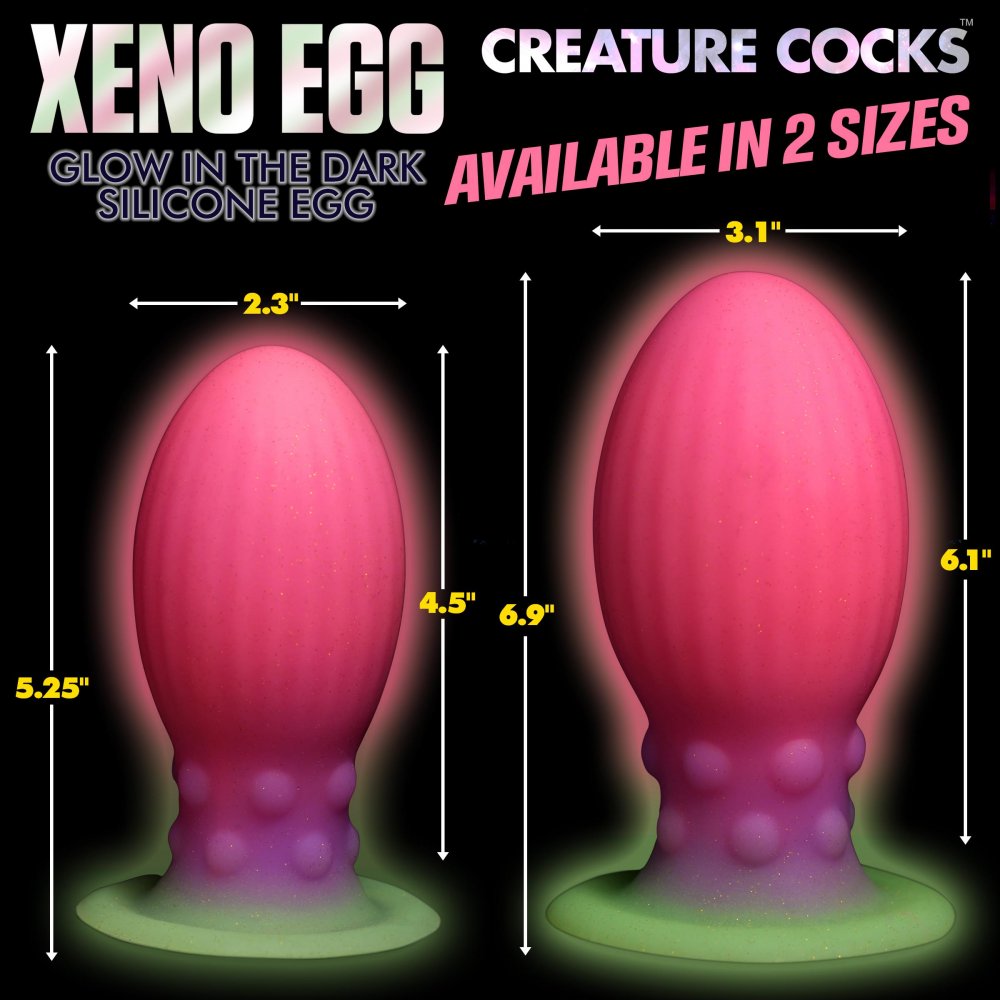 XL Xeno Egg Glow in the Dark Silicone Egg in vibrant pink, purple, and green colors, showcasing its ribbed texture and tapered tip.