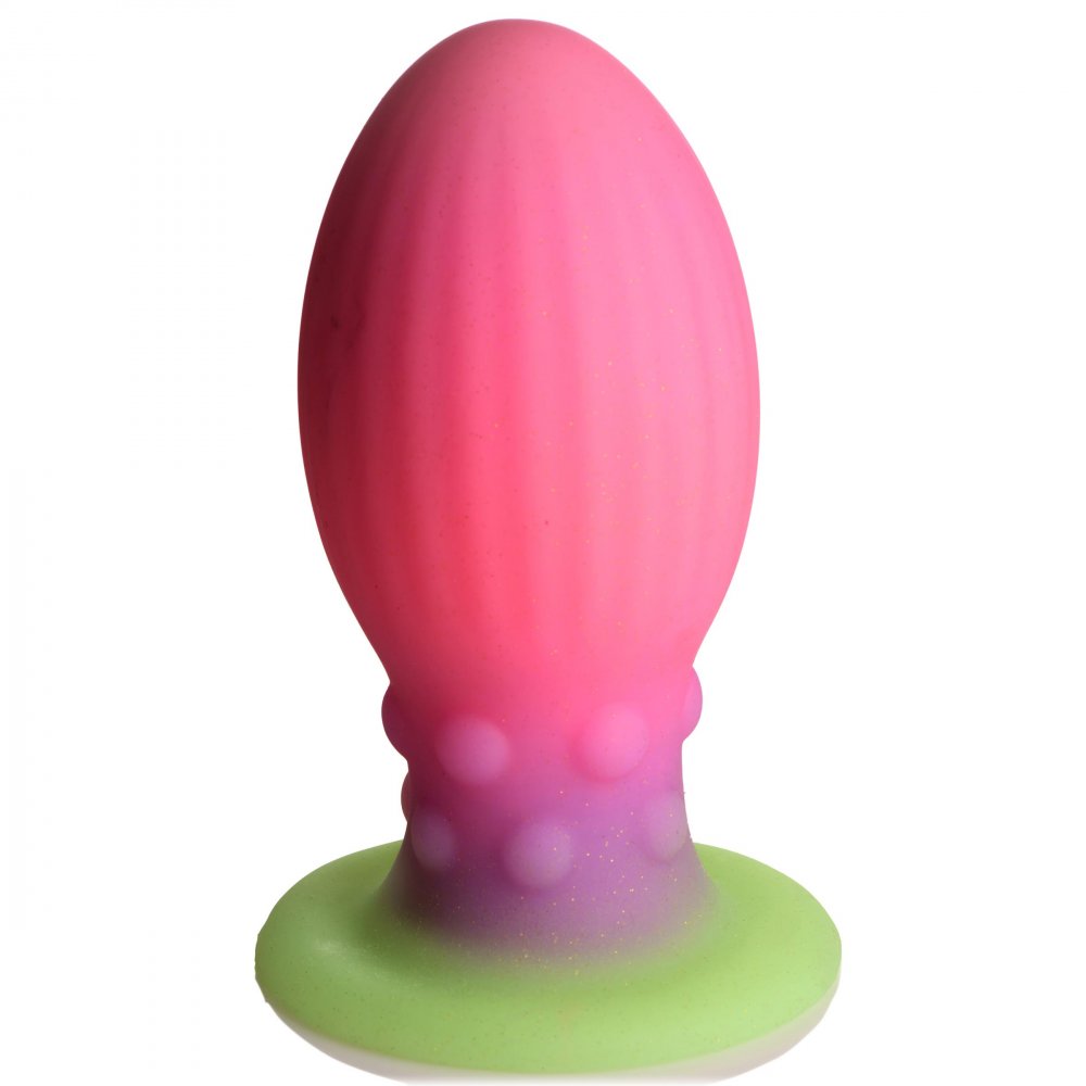 XL Xeno Egg Glow in the Dark Silicone Egg in vibrant pink, purple, and green colors, showcasing its ribbed texture and tapered tip.