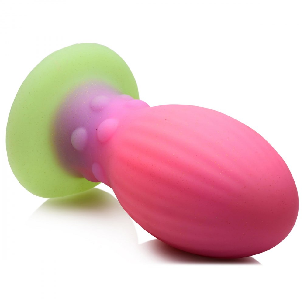 XL Xeno Egg Glow in the Dark Silicone Egg in vibrant pink, purple, and green colors, showcasing its ribbed texture and tapered tip.