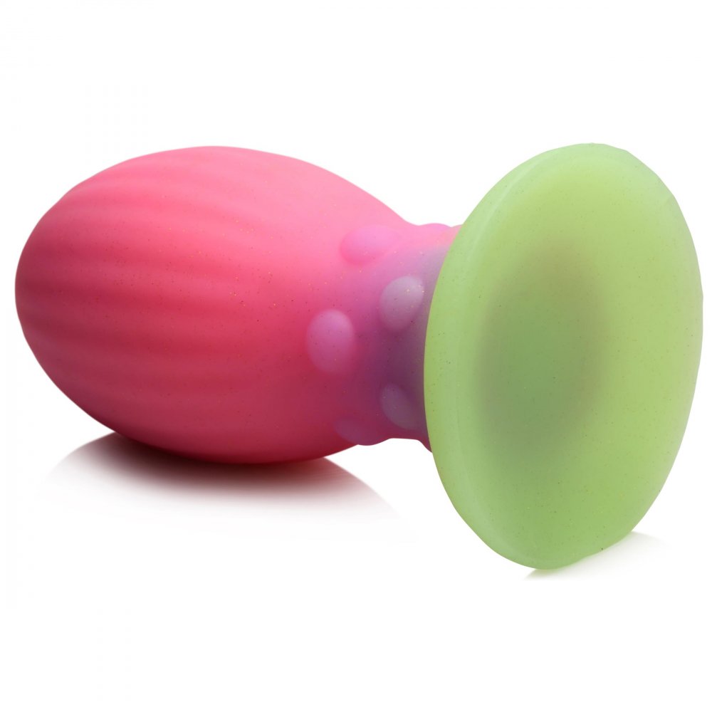 XL Xeno Egg Glow in the Dark Silicone Egg in vibrant pink, purple, and green colors, showcasing its ribbed texture and tapered tip.